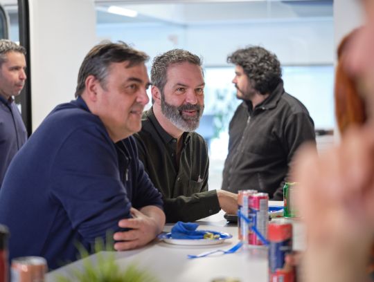 two employees talking at TIBO office lunch